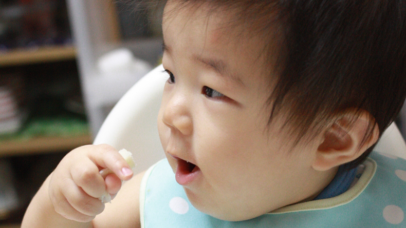 Baby eating by Tatsuo Yamashita cropped