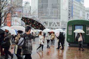 Tokyo, Japan - March 25, 2010: Photo of people near the Shibuya cross in Tokyo in a rainy day.