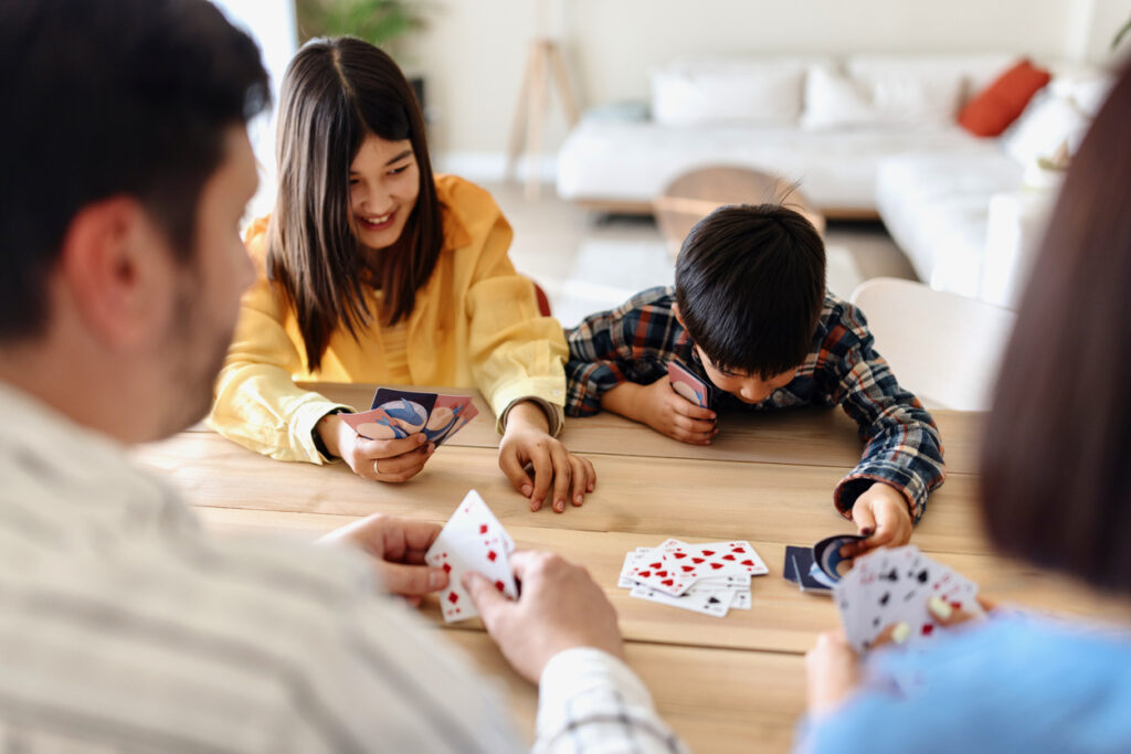 Beautiful family playing cards at home: Indoor Japanese Games