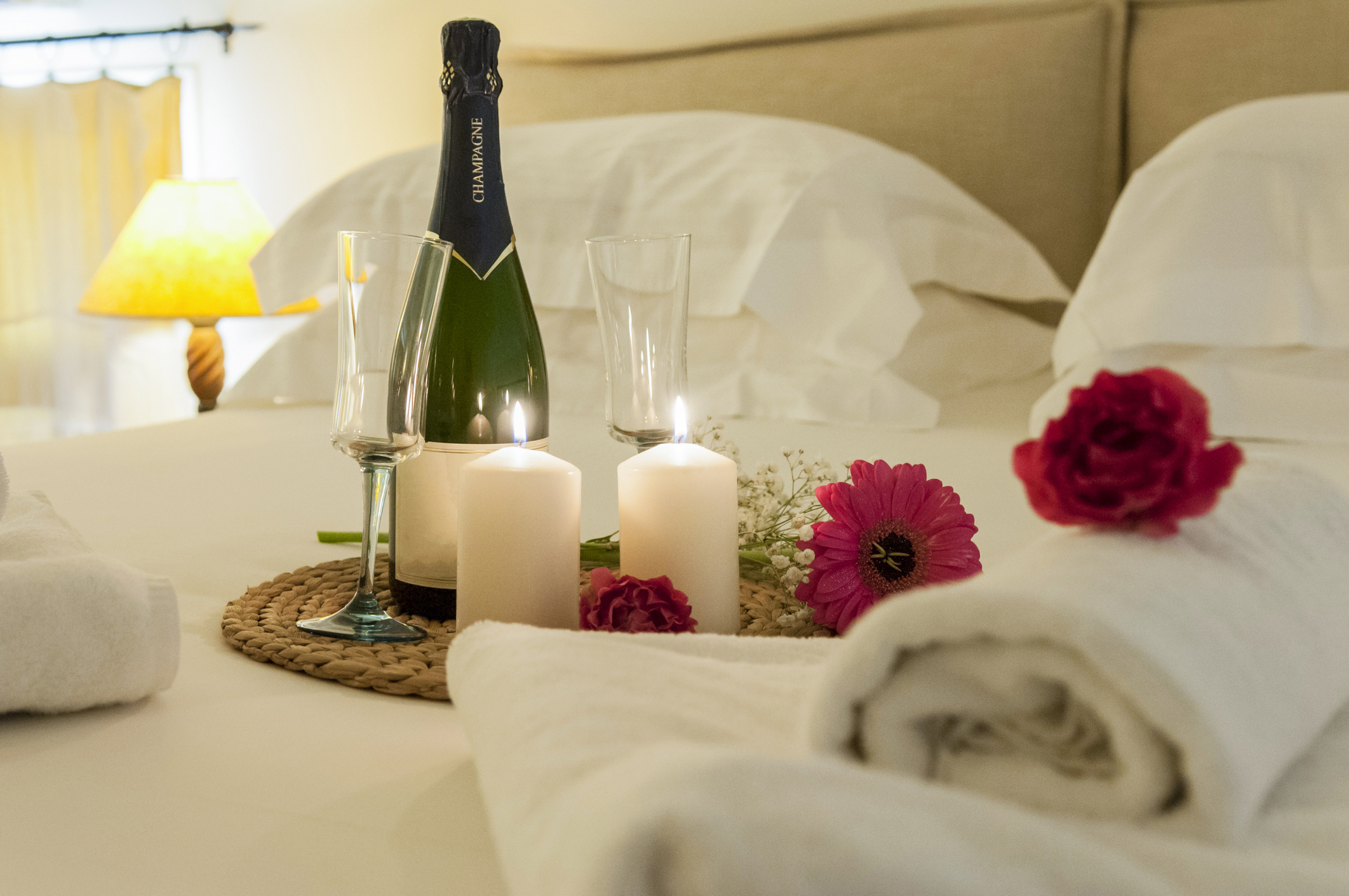 Japan’s Love Hotels: 10 Hotels To Suit Every Taste - Champagne bottle, candles, flowers on a bed in a hotel room