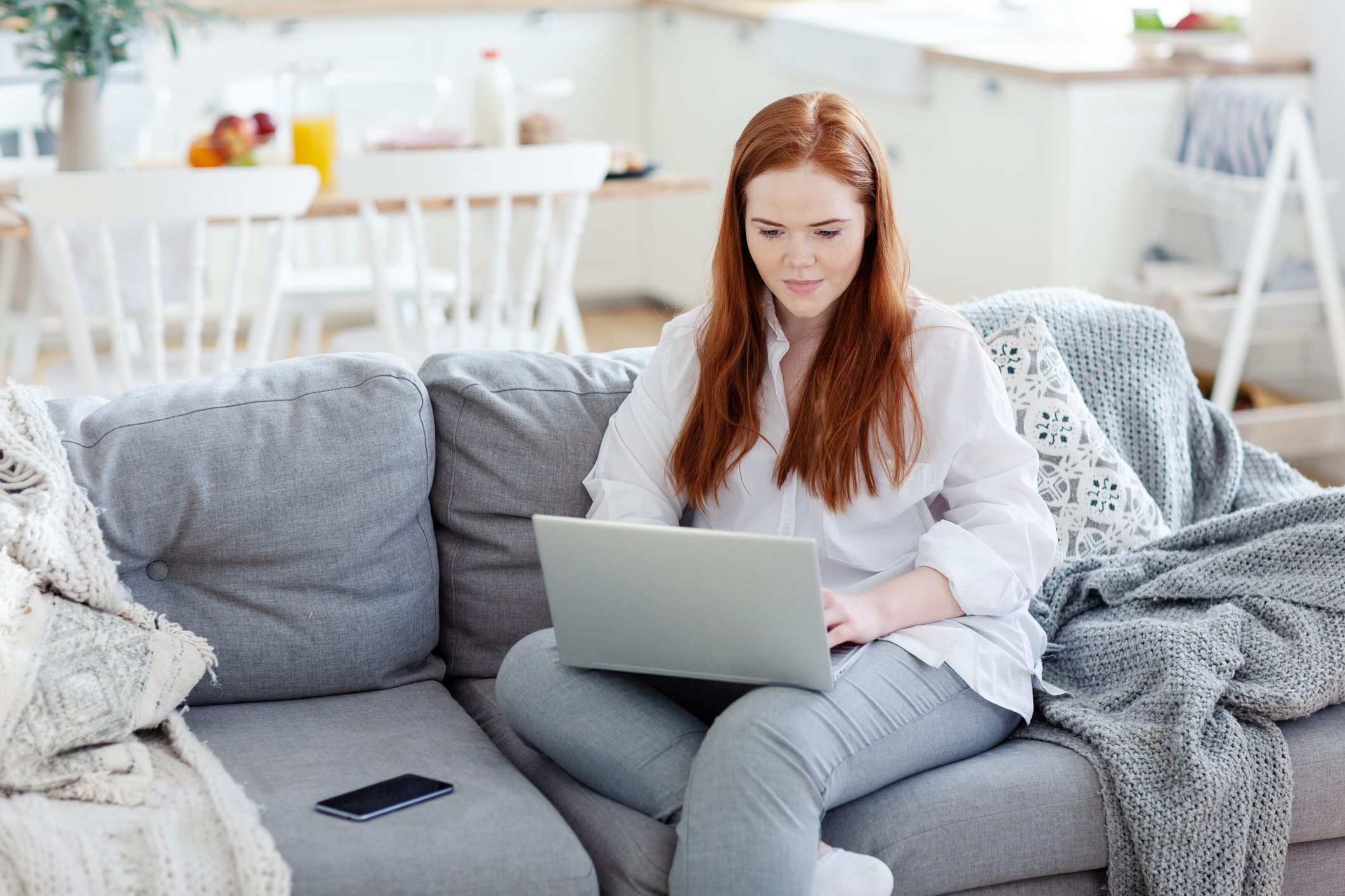 Lifestyle Illness: The ‘Other’ Checklist young woman seated on a couch, looking up things on internet