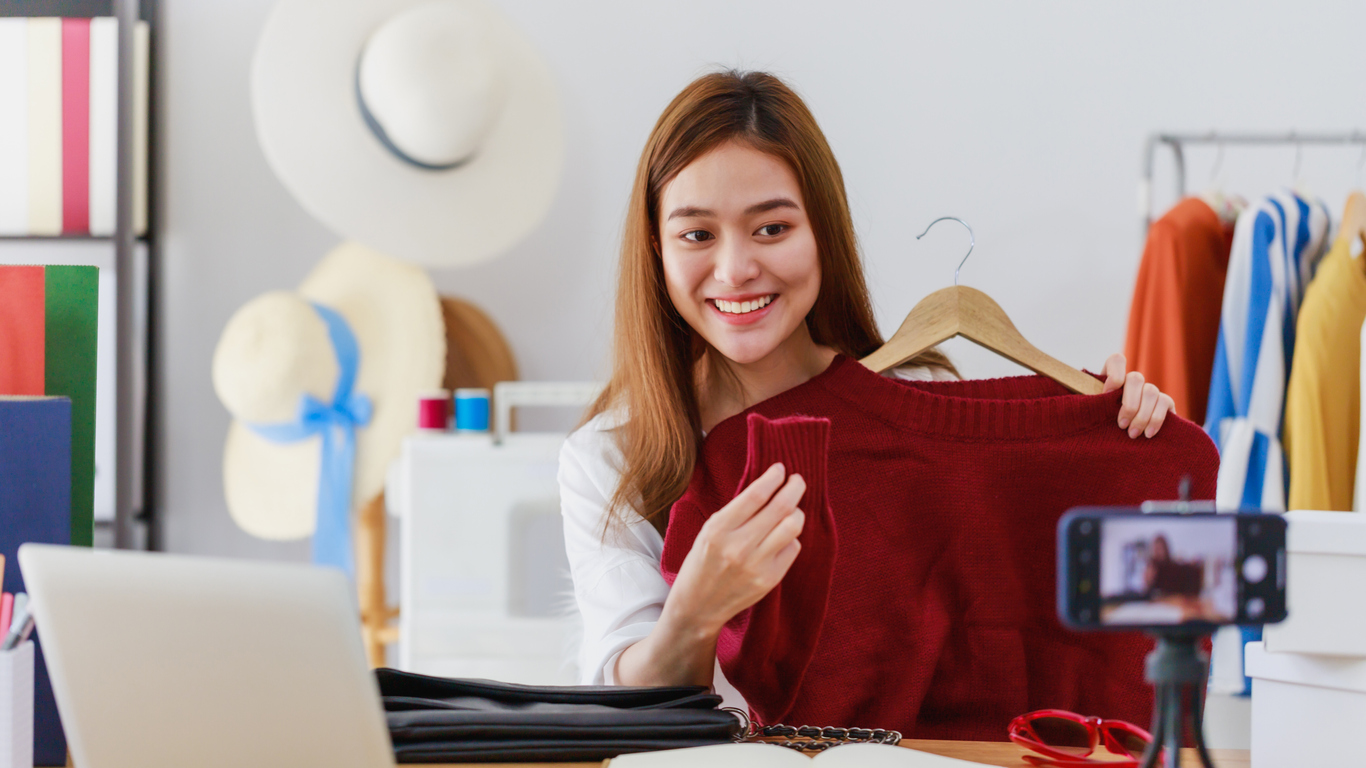 Beautiful asian woman blogger is showing and review product.In front of the  smartphone camera to recording vlog video live streaming at home.Business  online influencer on social media concept. - Savvy Tokyo