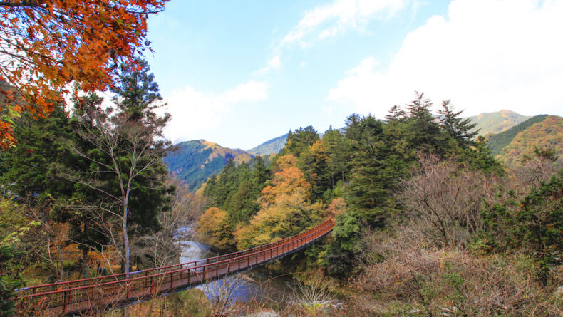 This red suspended bridge is a symbol of the Akigawa Valley and offers ...