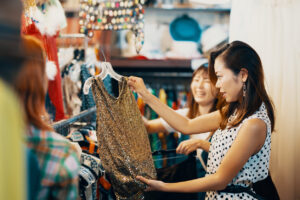Two female friends shopping in a vintage clothing store in Japan