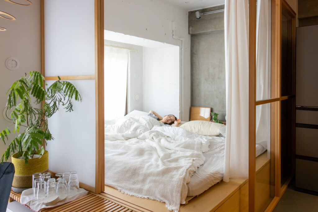 Young woman sleeping on bed in the morning